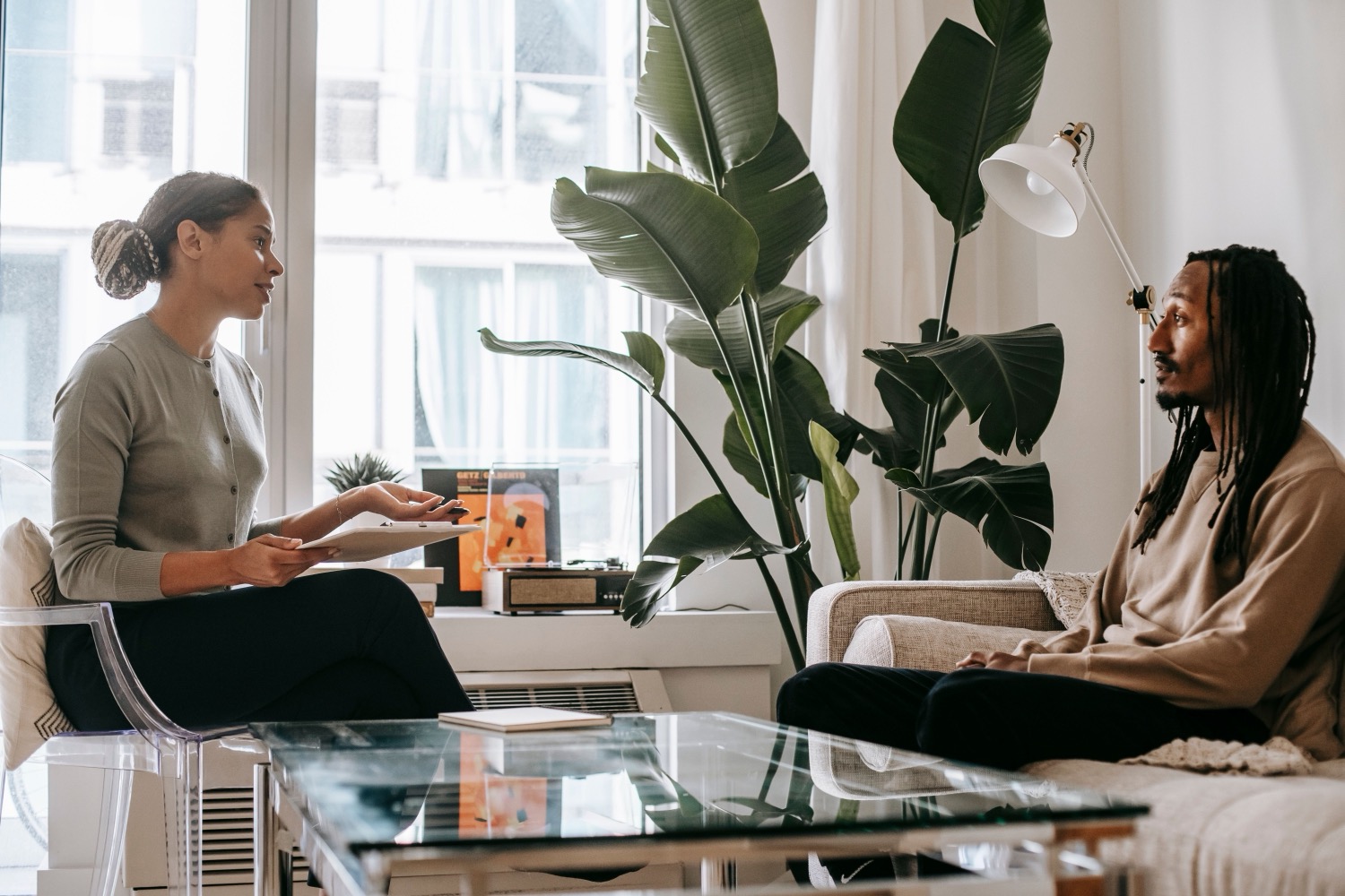 A counselor listens to a patient while reviewing information together.